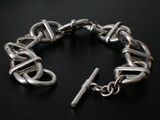silver chain bracelet with a clasp on a black background