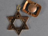 a close up of a star of david pendant and a star of david pendant