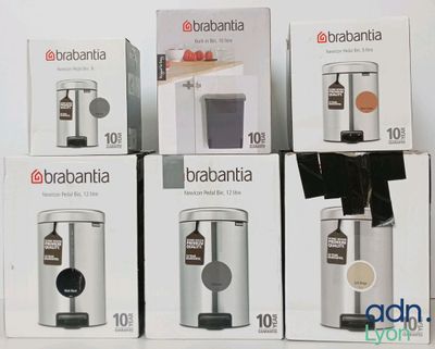 four boxes of coffee machines sitting on top of a white table