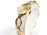 an image of a gold wrist watch on a white stand