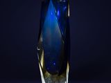 a blue glass vase on a black background