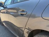 the car is parked on the side of the road in the parking lot