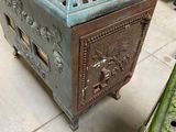 a green metal box sitting on the floor in a room