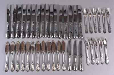 a lot of silverware on a table with a knife and fork