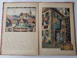 un livre ouvert sur lequel figure l'image d'une ville