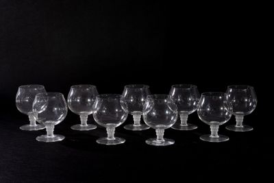 a lot of empty wine glasses on a black table