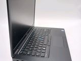 a laptop with a black keyboard on a white surface