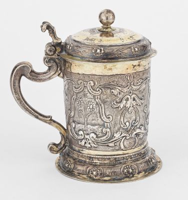 an old silver cup with a handle and a handle on it
