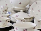 a lot of dishes and cups sitting on a table