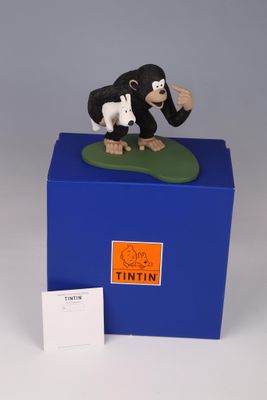 an image of a figurine of a monkey and a dog on top of a blue box