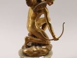 an image of a statue of an angel with a bow on a marble base