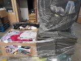 a large pile of clothes sitting on top of a pile of boxes