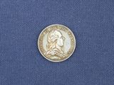 a close up of a coin on a blue cloth