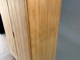 a tall wooden box with a handle on a table