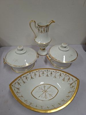 a white and gold plate with a bowl and two cups on it