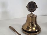 a bell and a hammer sitting on a table