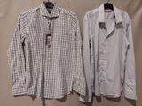 two men ' s shirts hanging on a hanger on a wall