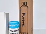 a bottle of water and a canister of water next to a box