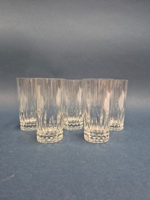 three glasses are lined up on a blue surface with a black background