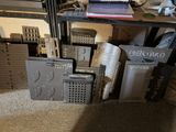 a desk with a laptop on top of it next to a pile of boxes