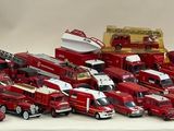 a lot of toy fire trucks that are on a table