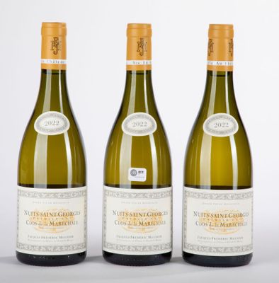 three bottles of white wine sitting next to each other on a table