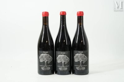 three bottles of wine sitting on top of a white table