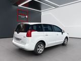 the small white car is parked in a large room