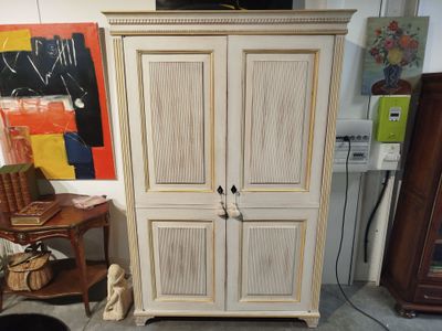 a cabinet that is sitting in the corner of a room