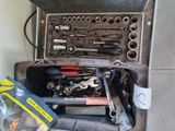 de nombreux outils dans une boîte à outils posée par terre