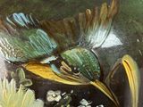 a vase that has a bird painted on it