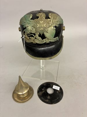 a black hat with a gold eagle on it next to a brass bell