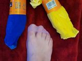 a person ' s feet on a towel next to a pair of socks and a pair of socks