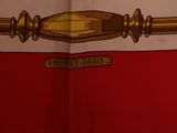 a picture of a red and white scarf with a gold handle