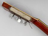 an old rifle with a wooden body and brass fittings on it