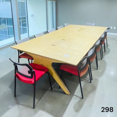 a long table with red chairs and a yellow table top