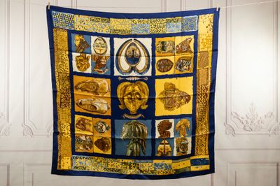 a blue and yellow quilt with pictures of people on it