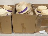 three boxes of straw hats are stacked on top of each other