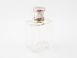 a bottle of perfume sitting on a white surface