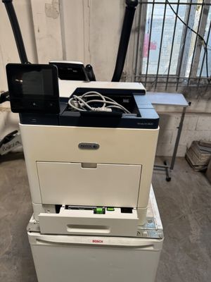 an image of a printer sitting on top of a stack of boxes