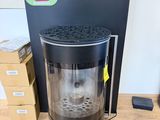 an image of a coffee maker sitting on top of a wooden floor