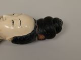 a figurine of a woman laying down on a table