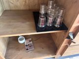 a shelf that has a bunch of glasses on top of it