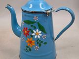 an image of a blue tea pot with flowers painted on it