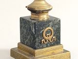 a statue of a man with a hat on top of it
