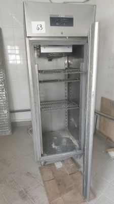 an empty refrigerator in the middle of a room