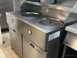 a stainless steel kitchen with a sink and a stove