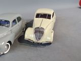 two toy cars sitting next to each other on the floor
