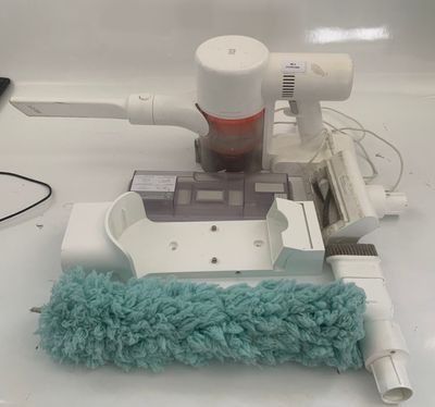 a mop and a duster on a counter top