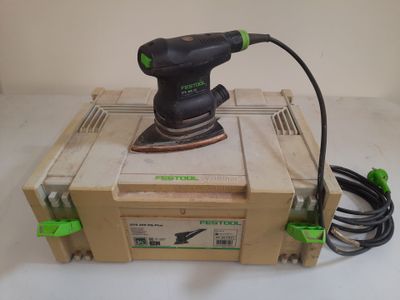 an electric sander sitting on top of a box with a cord